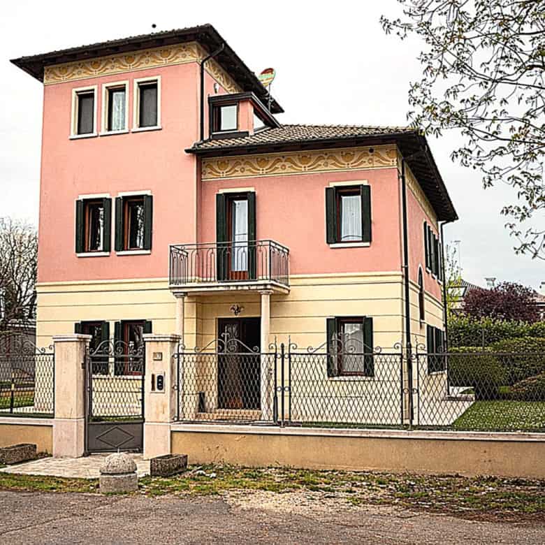 Elegant pink villa with modern design and spacious garden.
