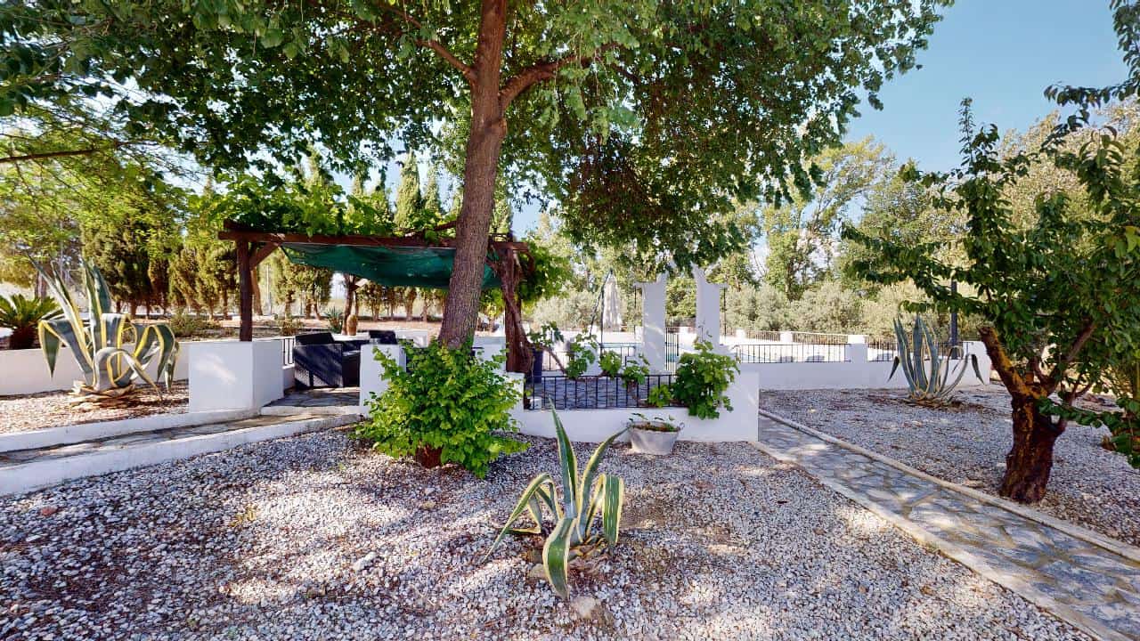 Charming boutique hotel for sale in Caniles, Granada, featuring beautiful outdoor gardens and relaxi.