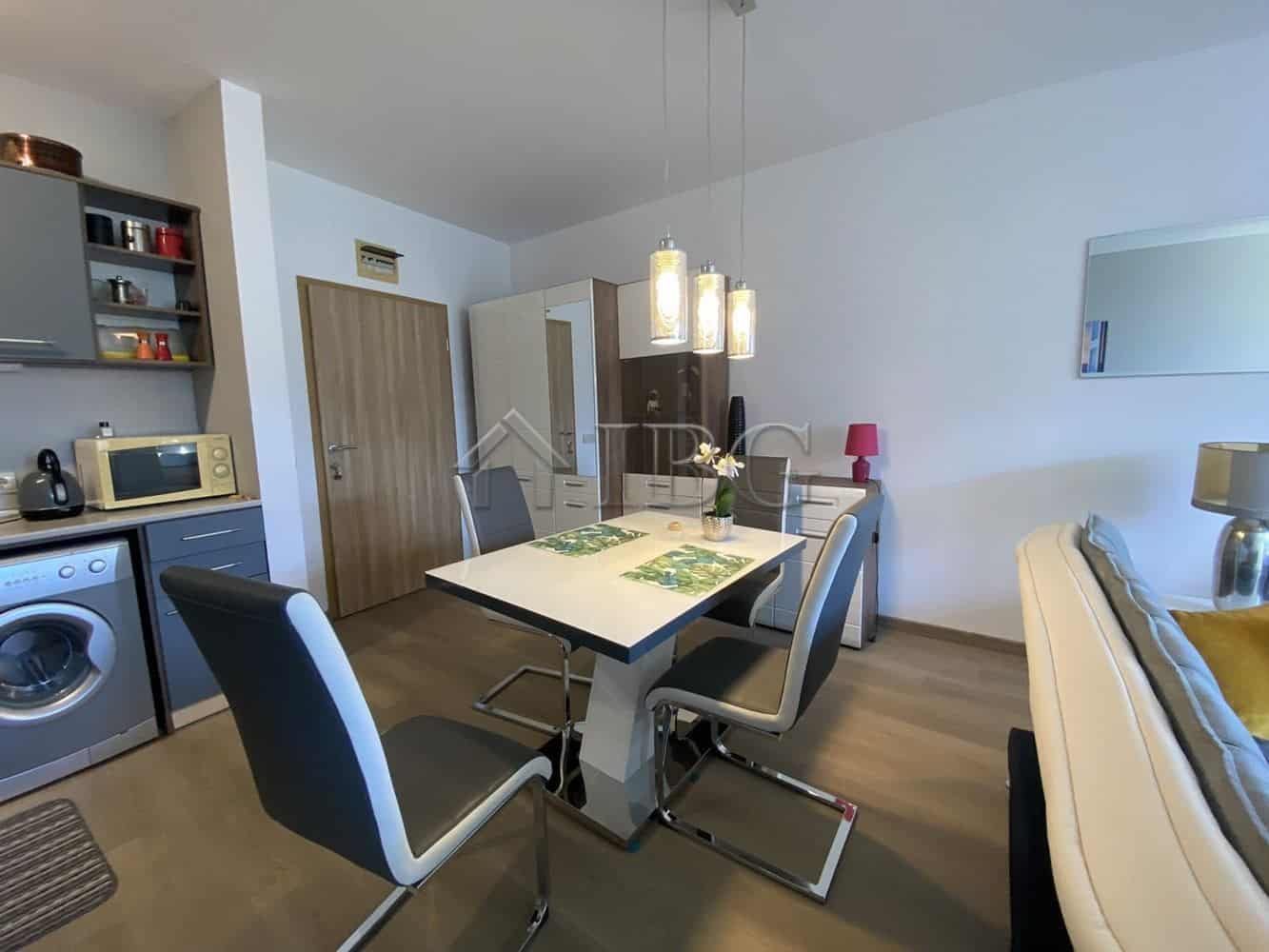 Bright interior of a one-bedroom apartment with a private yard in Vineyards Resort, Aheloy, Bulgaria.