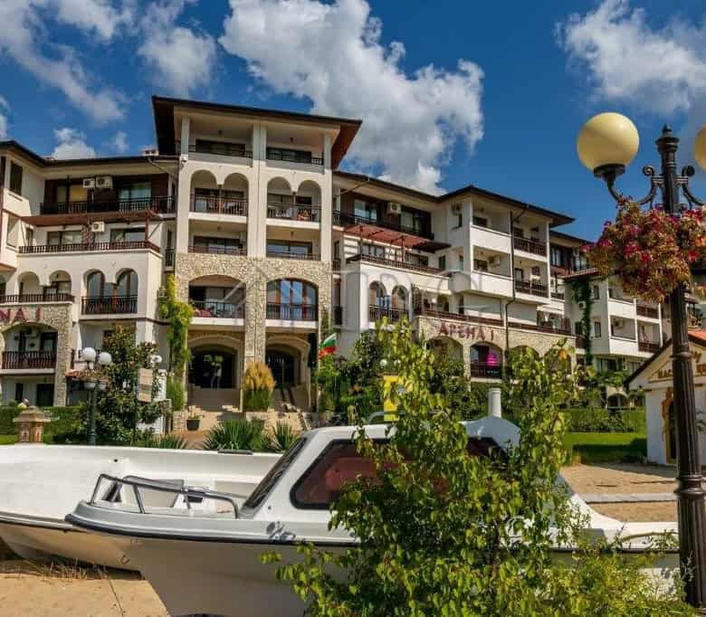 Seaside apartment building in Sveti Vlas with balconies, gardens, and sea views.