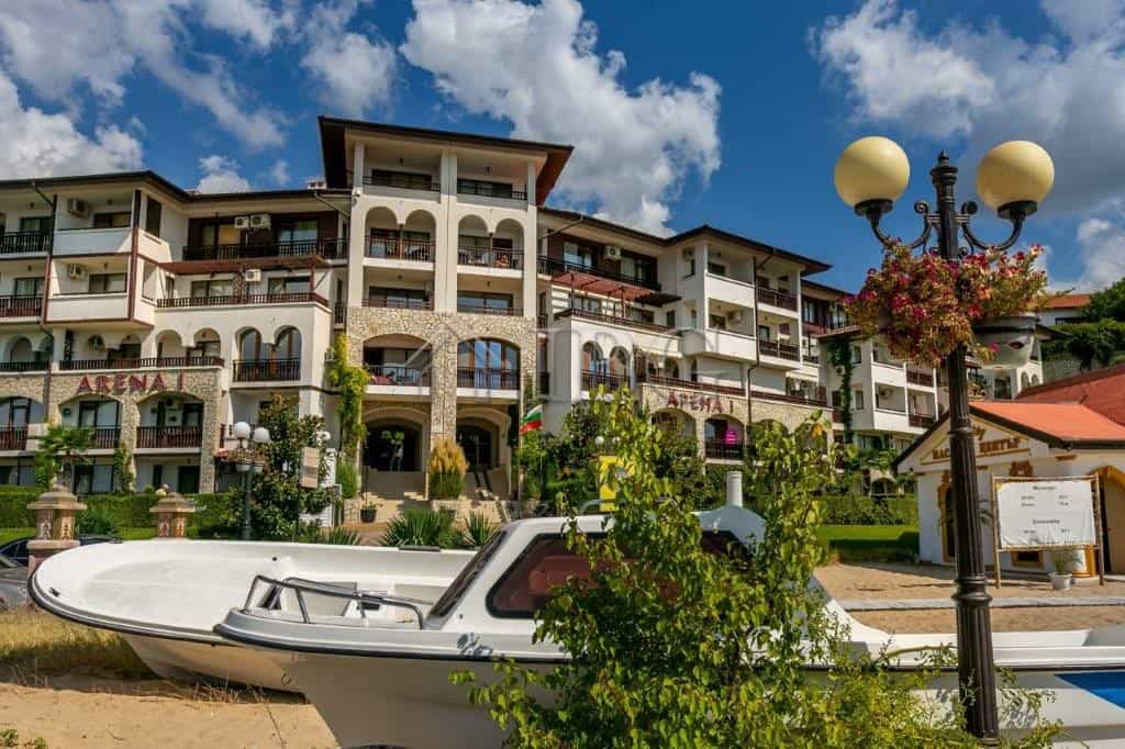 Seaside apartment building in Sveti Vlas with balconies, gardens, and sea views.