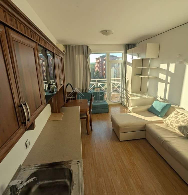 Furnished studio apartment with balcony in Sunny Beach, featuring a cozy living area and modern amen.