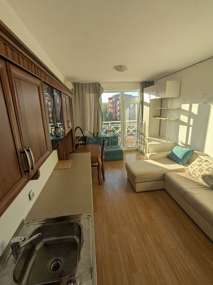 Furnished studio apartment with balcony in Sunny Beach, featuring a cozy living area and modern amen.