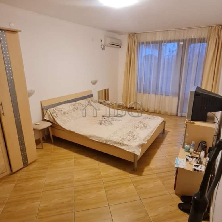 Spacious bedroom with large window, bed, and minimal decor in Sunny Beach apartment.