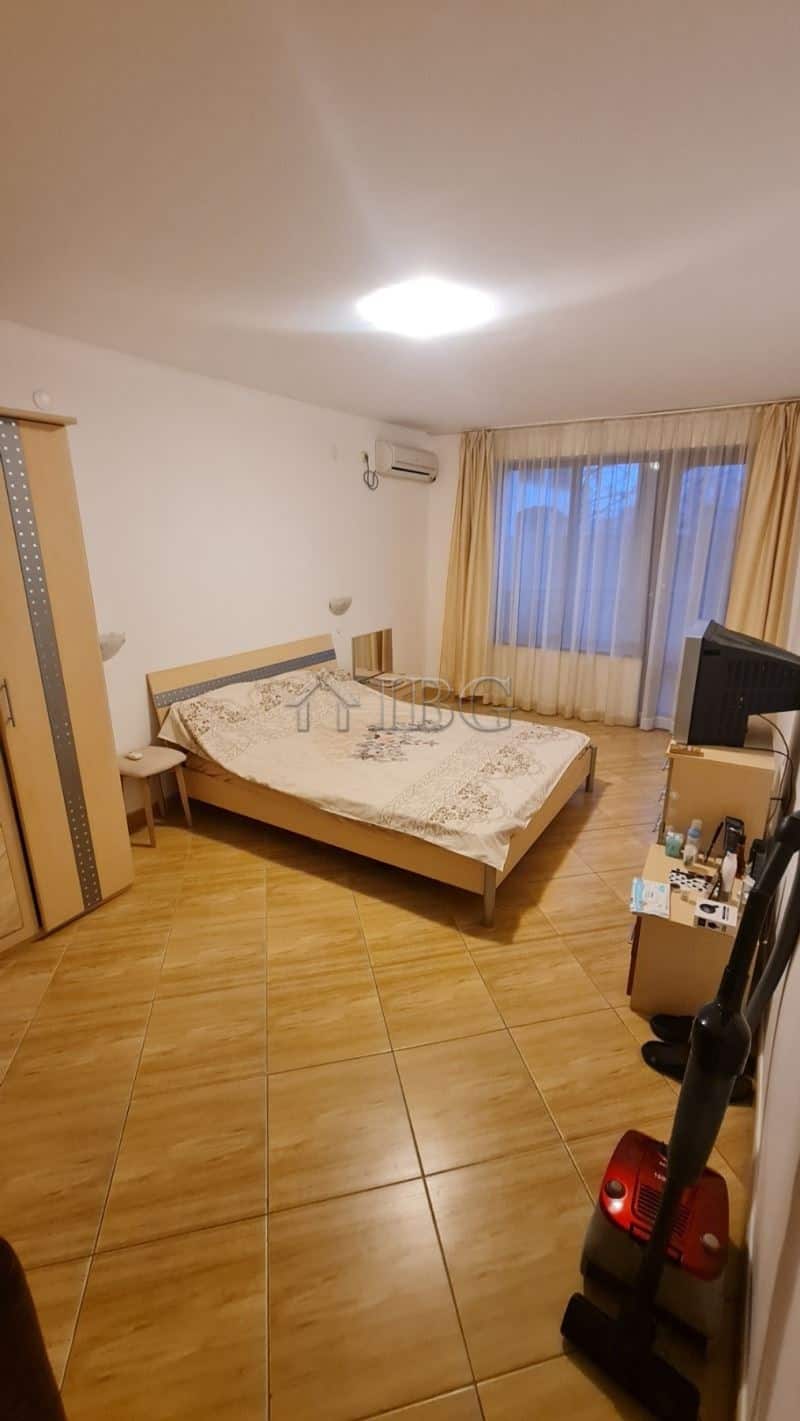 Spacious bedroom with large window, bed, and minimal decor in Sunny Beach apartment.