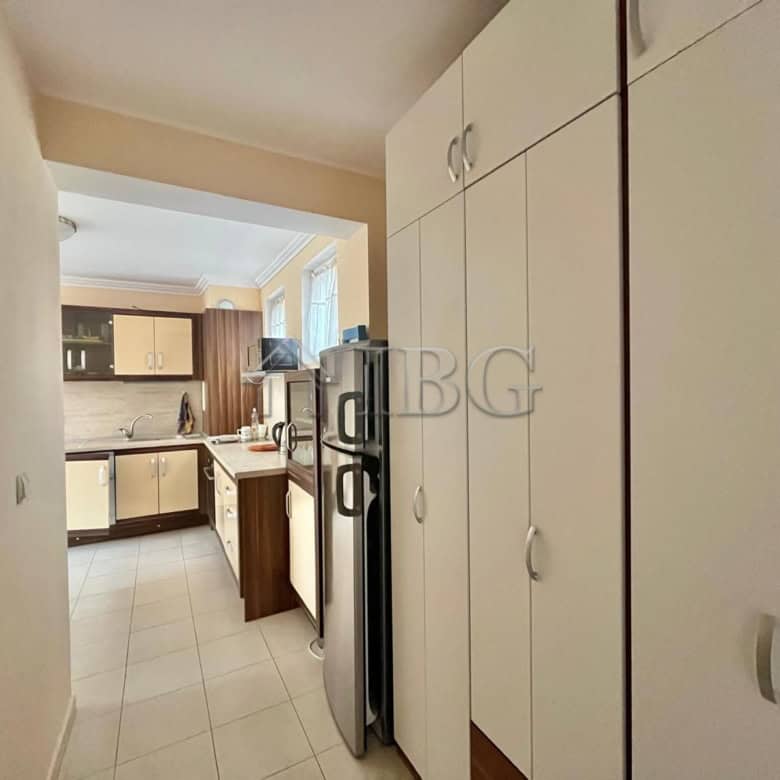 Modern kitchen with white cabinets, refrigerator, and natural light in Laguna 3, Sunny Beach.
