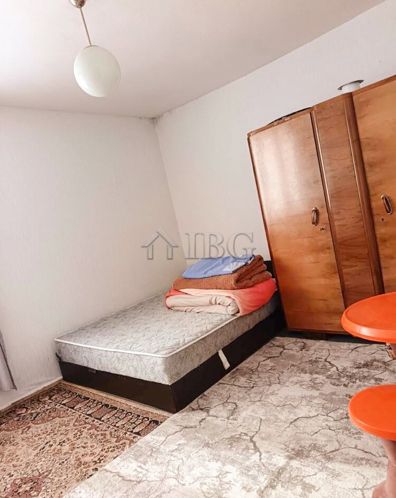 Bright interior of a well-maintained two-storey house with a bedroom, wardrobe, and garden access.