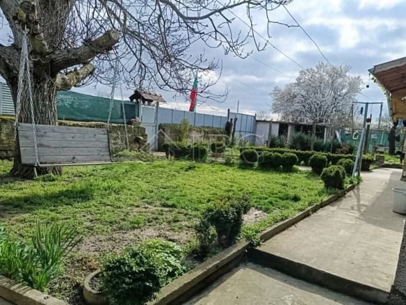 Well-maintained two-storey house with garage and lush garden near Ruse, Bulgaria.