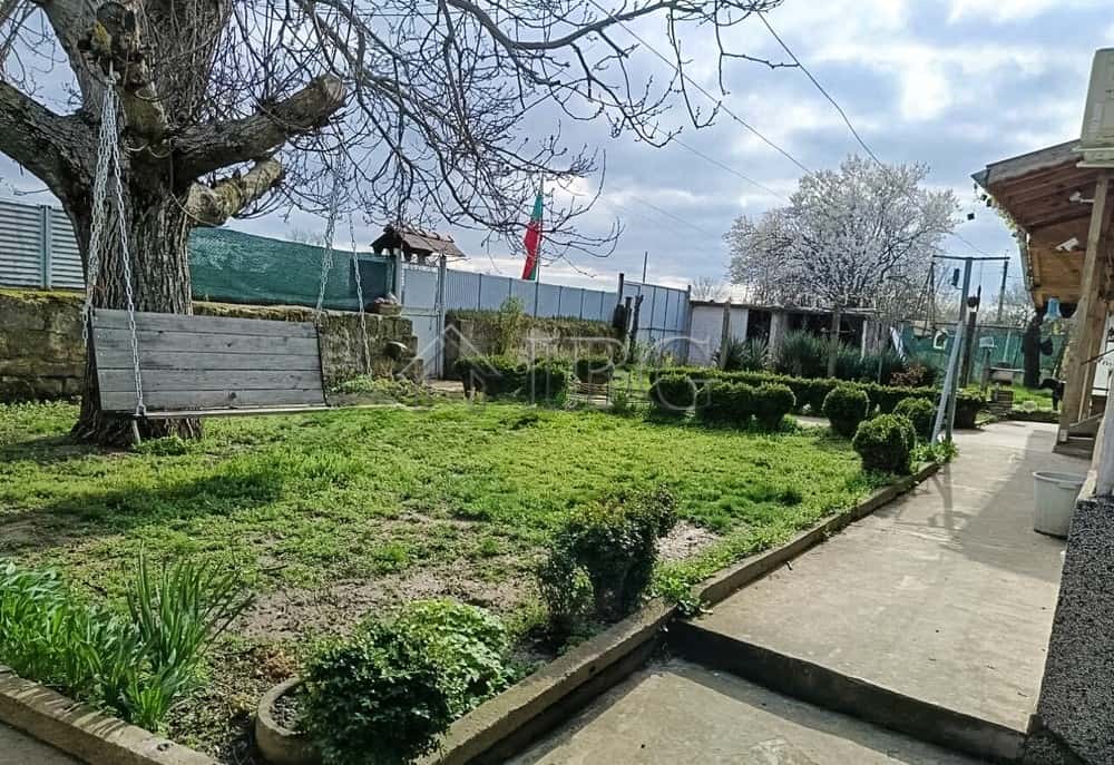 Well-maintained two-storey house with garage and lush garden near Ruse, Bulgaria.
