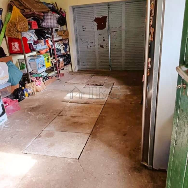 Garage with storage space and metal sliding door in a well-maintained house.
