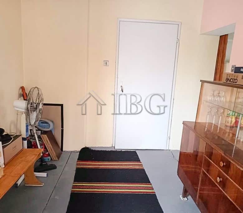 Bright entrance of a well-maintained two-storey house with a garden and garage.