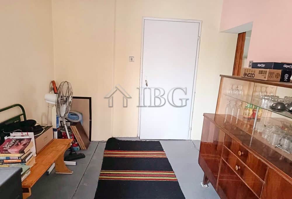 Bright entrance of a well-maintained two-storey house with a garden and garage.
