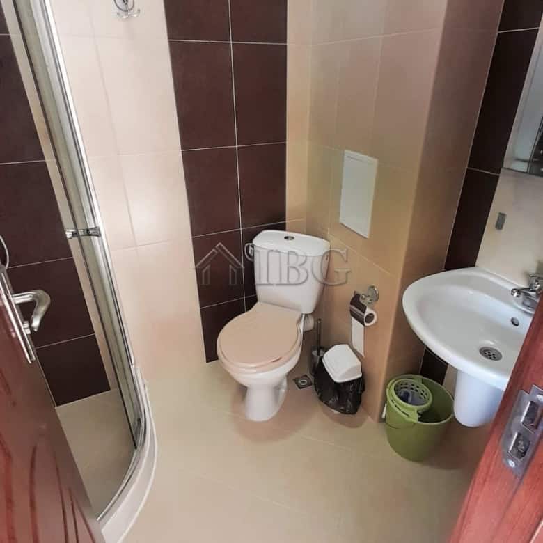 Small bathroom with toilet, sink, and shower at Cascadas Family Resort, Sunny Beach.