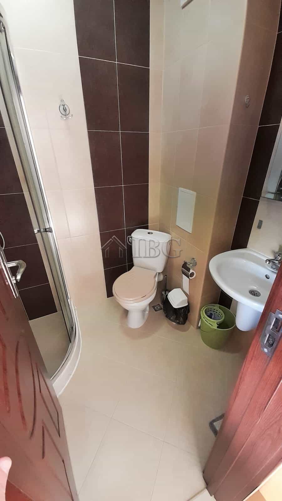 Small bathroom with toilet, sink, and shower at Cascadas Family Resort, Sunny Beach.