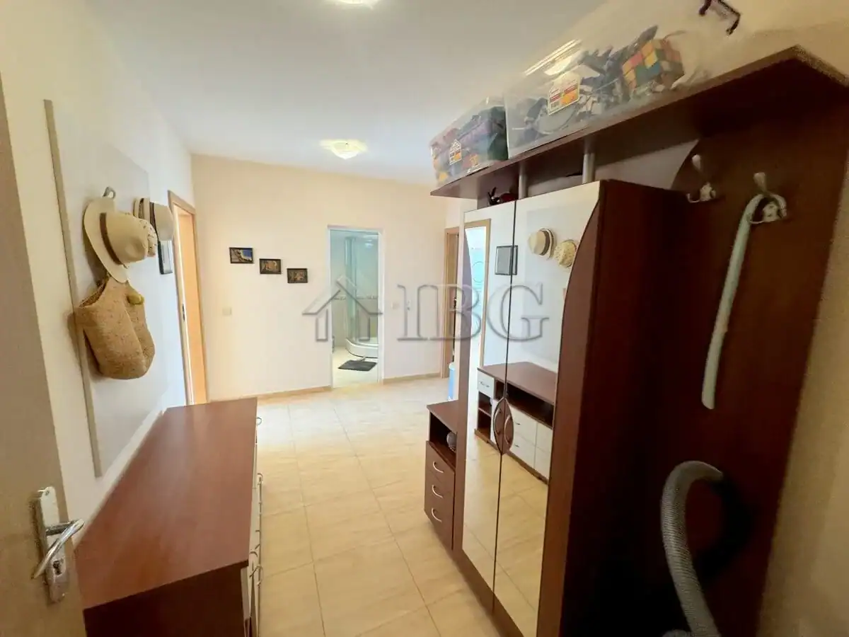 Interior view of a 2-bedroom apartment in Sveti Vlas, Bulgaria, with furniture and hallway.