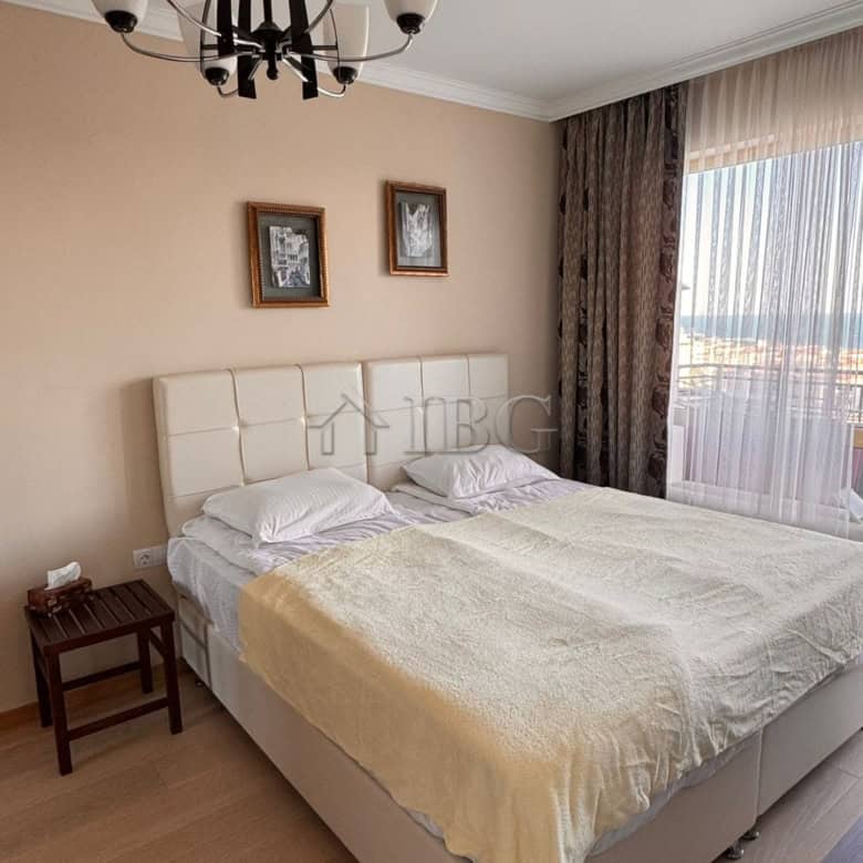 Spacious bedroom with a large bed, modern decor, and natural light in Villa Florence, Sveti Vlas.