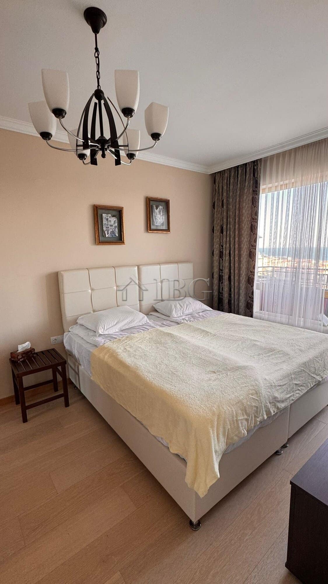 Spacious bedroom with a large bed, modern decor, and natural light in Villa Florence, Sveti Vlas.
