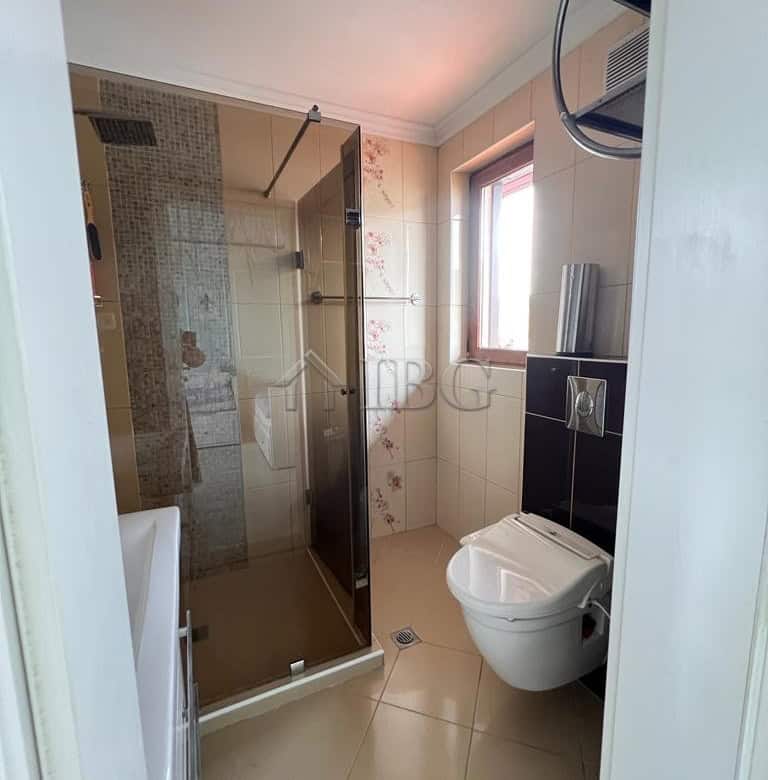 Bathroom with glass shower, toilet, and natural light in Sveti Vlas.