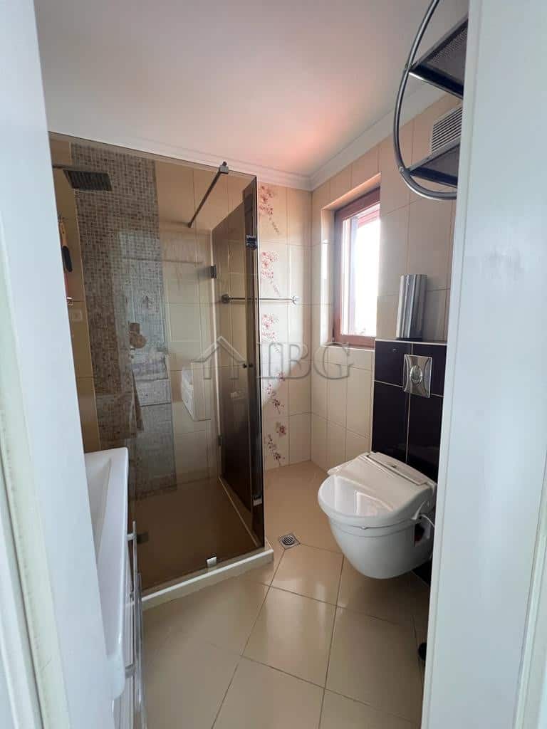 Bathroom with glass shower, toilet, and natural light in Sveti Vlas.