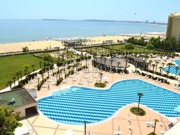Beachfront pool at Majestic Beach Resort, Sunny Beach, Bulgaria, with ocean views and lush surroundi.