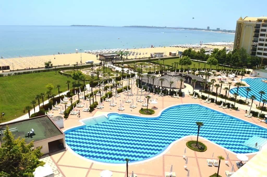 Beachfront pool at Majestic Beach Resort, Sunny Beach, Bulgaria, with ocean views and lush surroundi.