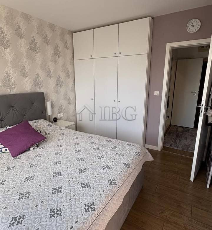 Bright bedroom featuring a large bed, wardrobe, and modern decor in Pomorie Residence.