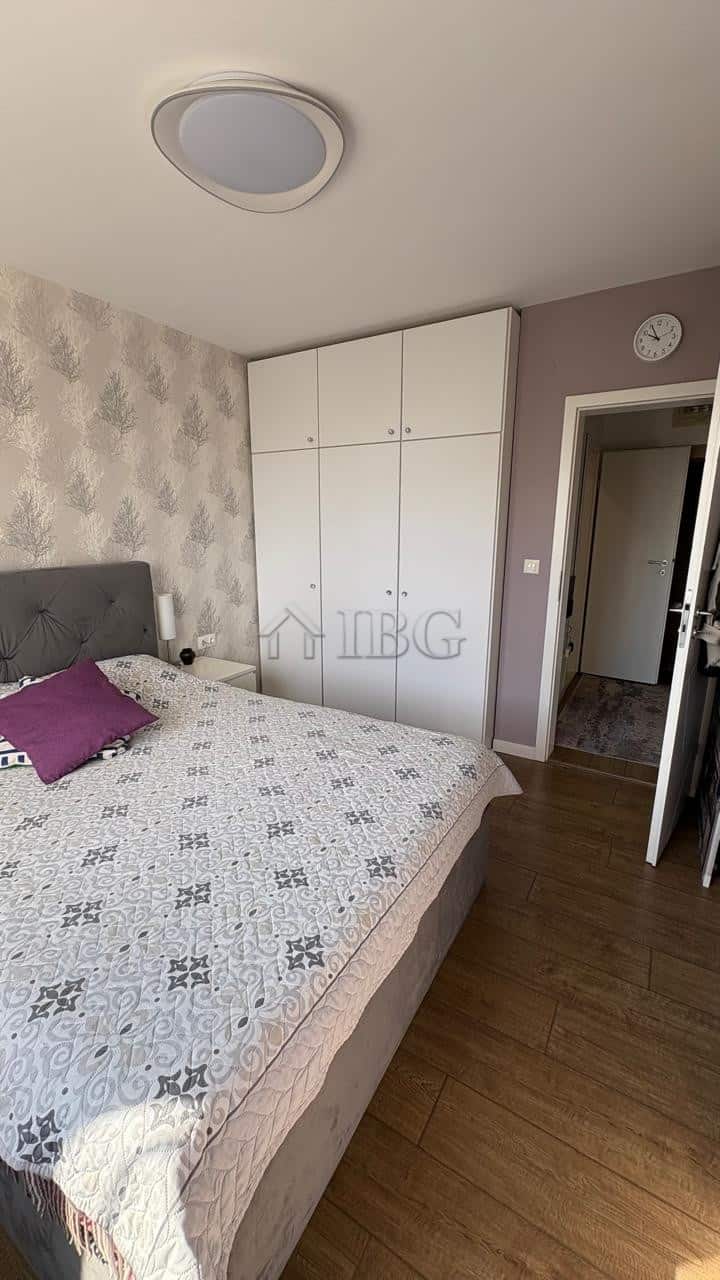 Bright bedroom featuring a large bed, wardrobe, and modern decor in Pomorie Residence.