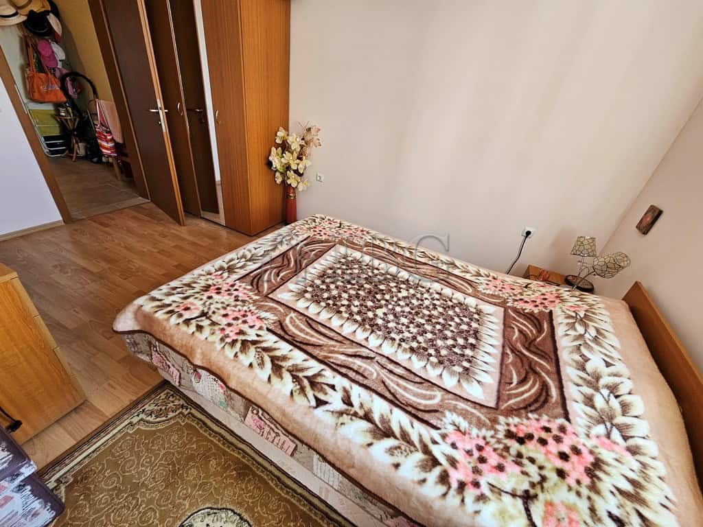 Sea view bedroom with cozy decor and large window.