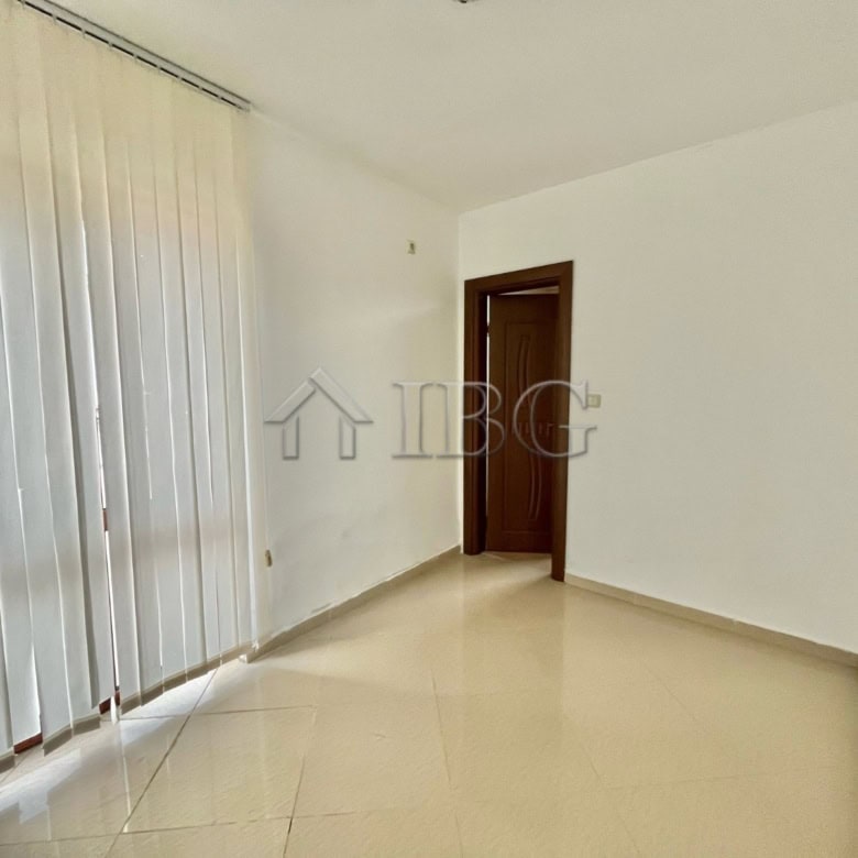 Bright living room with large window and sliding door in Aleksandrovo, Burgas.