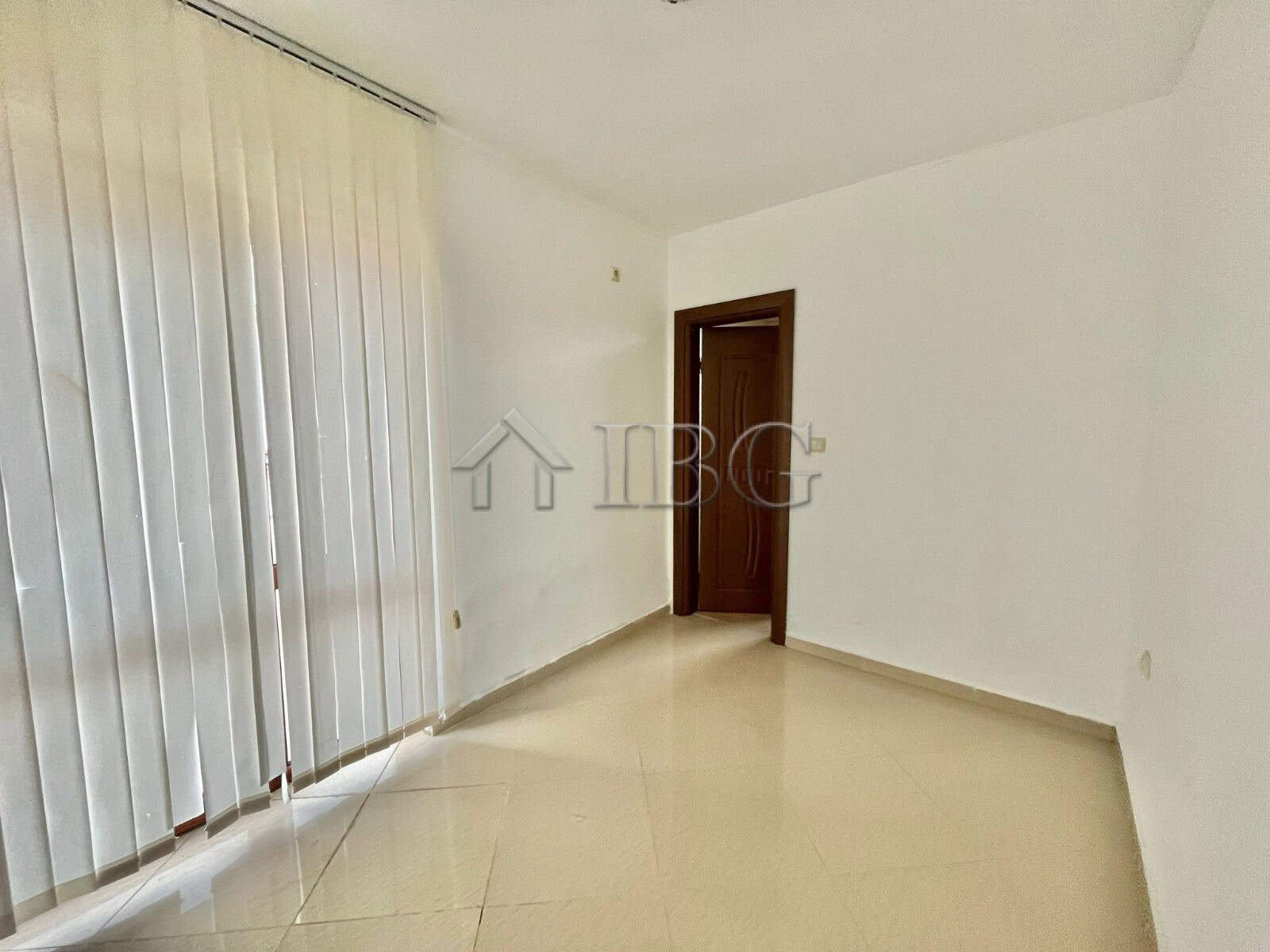 Bright living room with large window and sliding door in Aleksandrovo, Burgas.