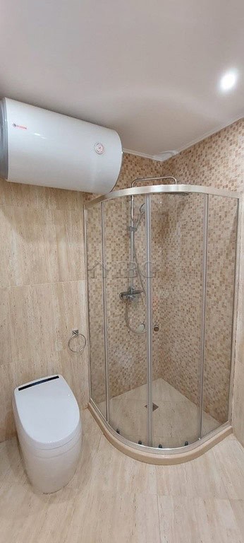 Bathroom with shower enclosure and modern toilet in Sveti Vlas apartment.