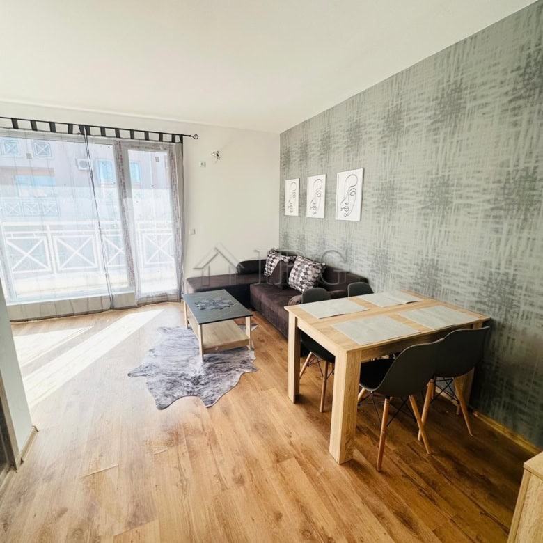 Bright living room with balcony access in Sunny Beach. Modern furniture and natural light create a w.