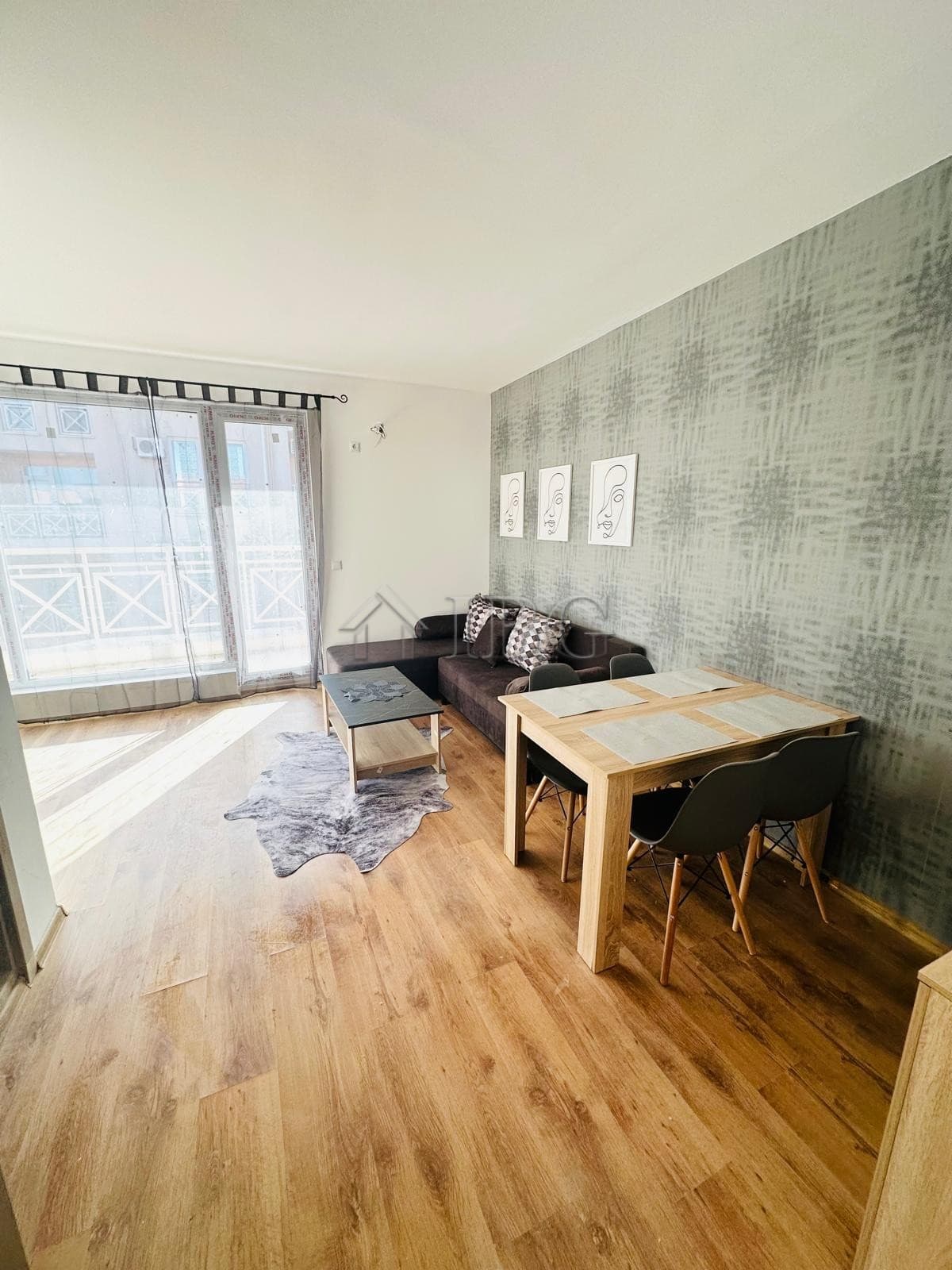 Bright living room with balcony access in Sunny Beach. Modern furniture and natural light create a w.