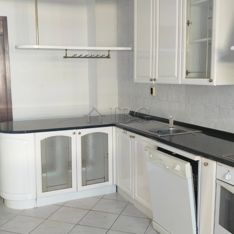 White kitchen with cabinets, countertop, and sea view in Sveti Vlas.