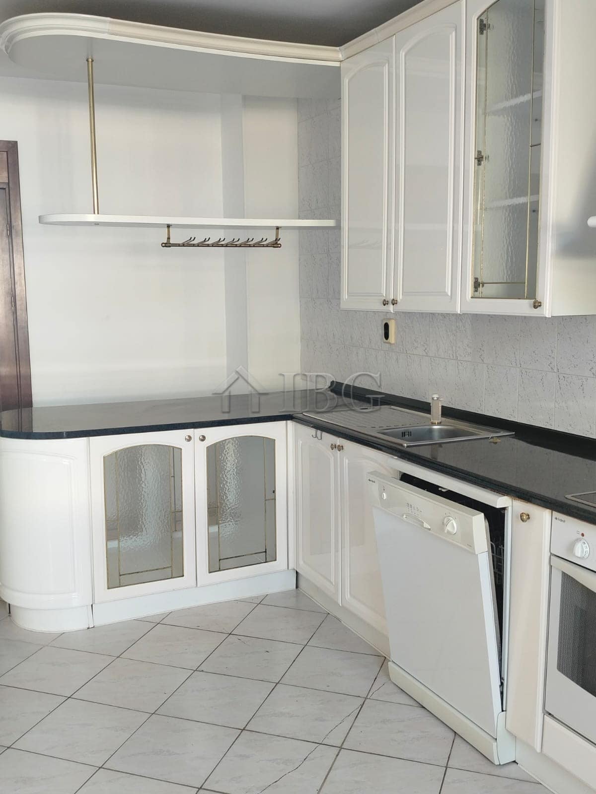 White kitchen with cabinets, countertop, and sea view in Sveti Vlas.