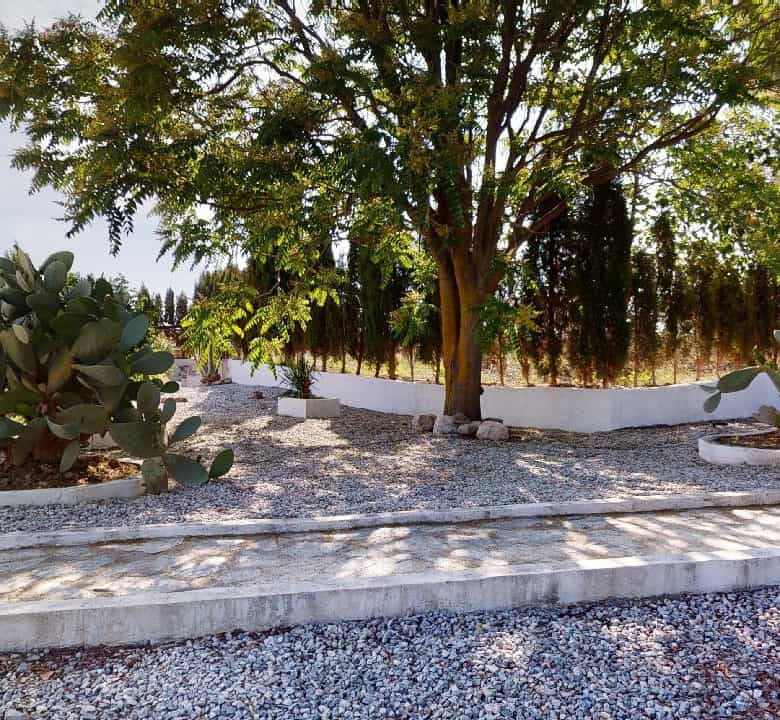 Charming boutique hotel for sale in Caniles, Granada, featuring lush gardens and outdoor seating are.