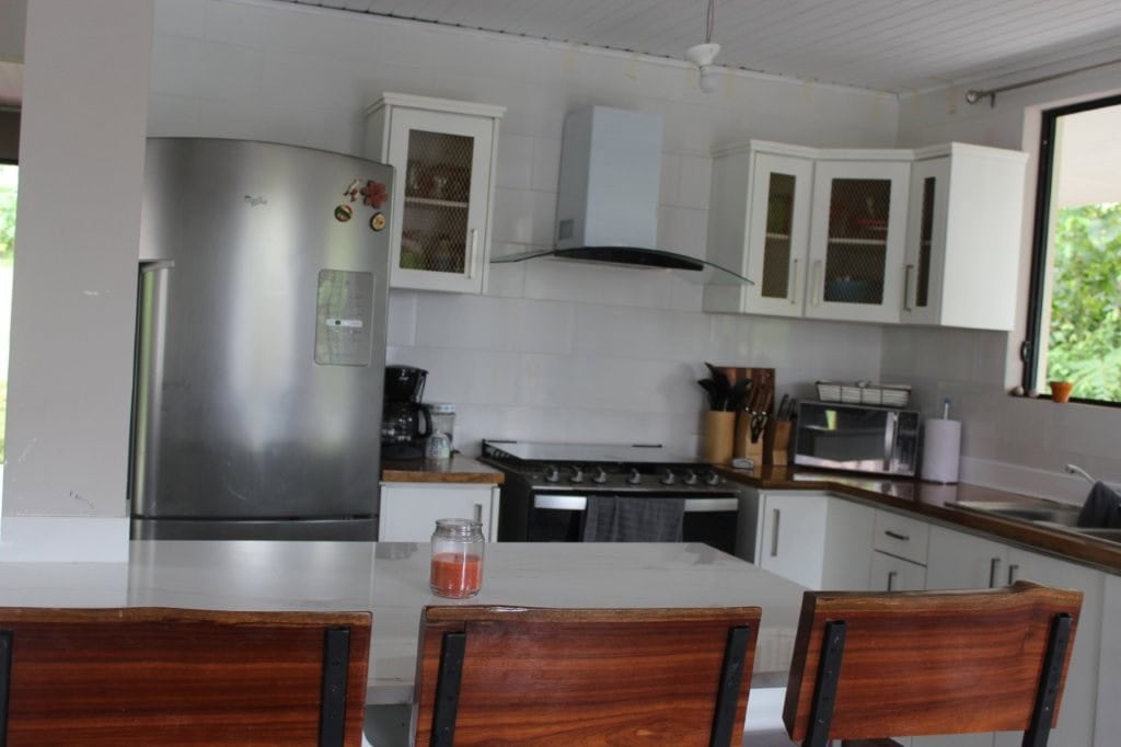 Spacious kitchen with white cabinets, stainless steel appliances, and a breakfast bar in a beautiful.