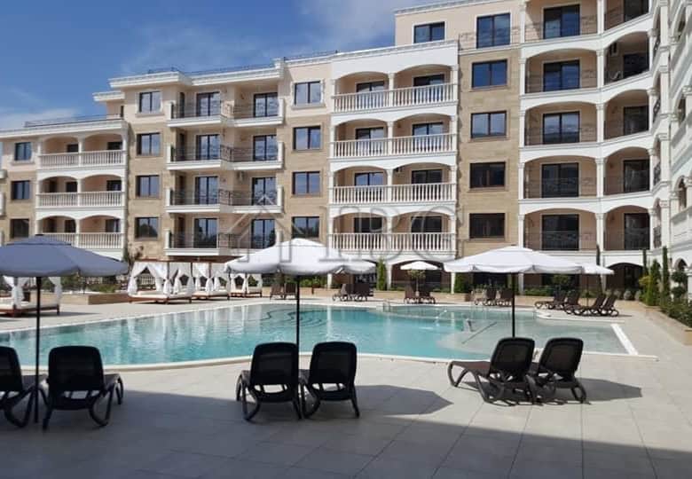 View of a luxury apartment building with a swimming pool in Nessebar, Bulgaria.