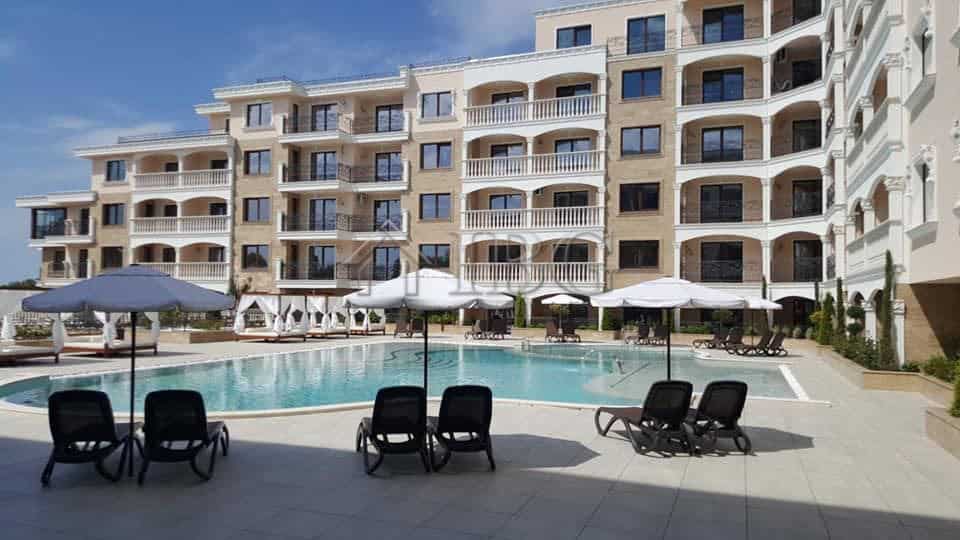 View of a luxury apartment building with a swimming pool in Nessebar, Bulgaria.
