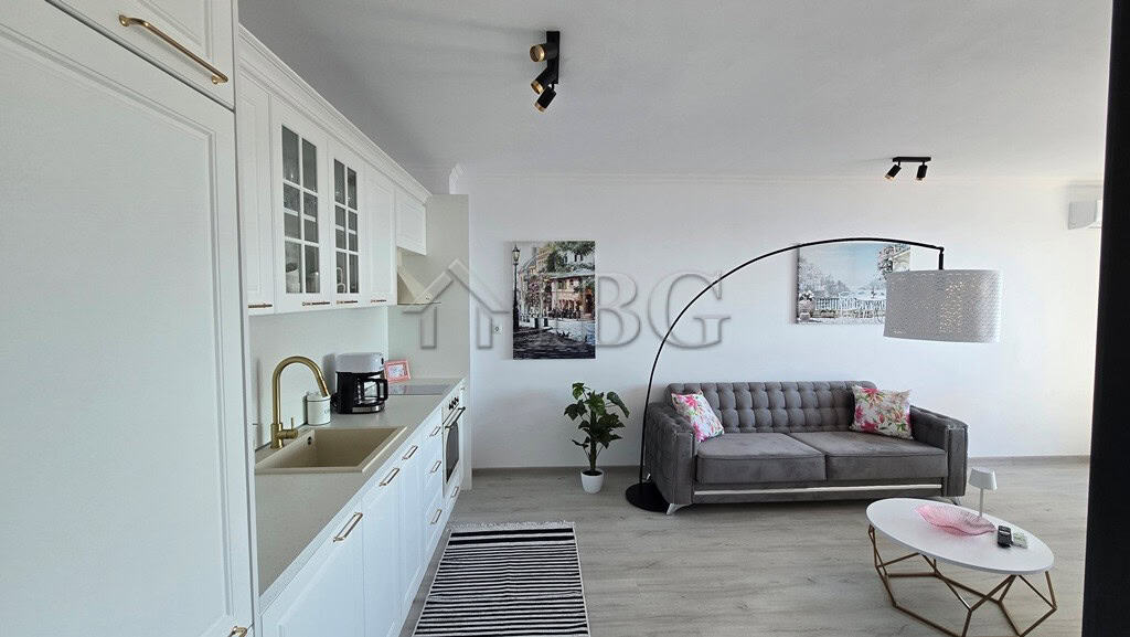 Spacious living area with contemporary decor in a luxury Sveti Vlas apartment, featuring a comfortab.