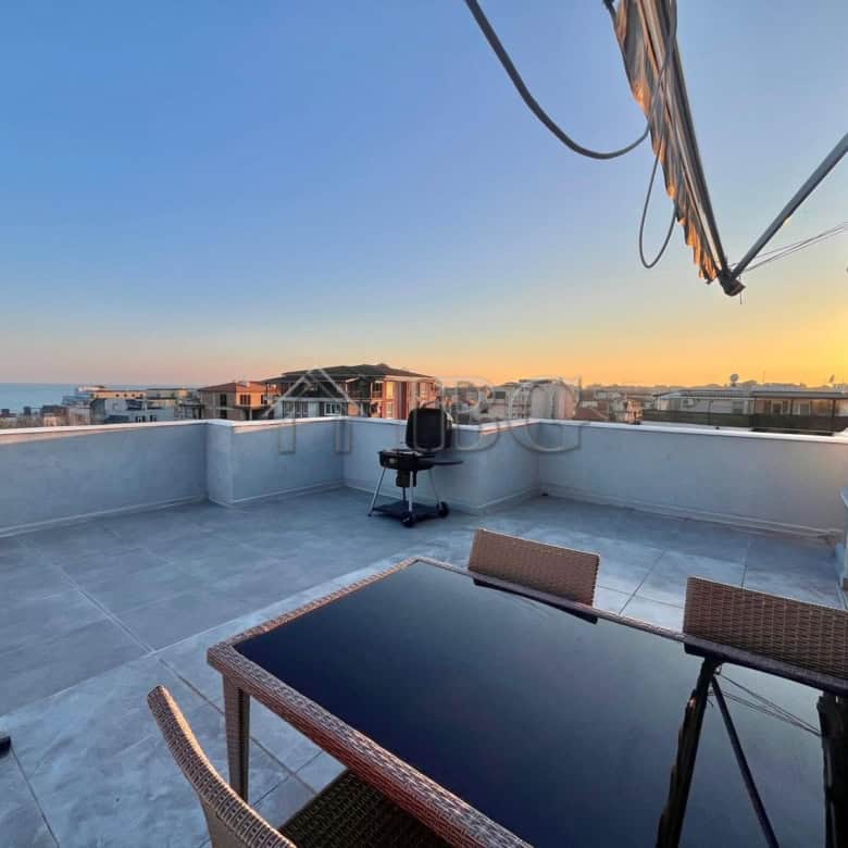 Rooftop terrace with sea view and outdoor furniture in Ravda apartment.