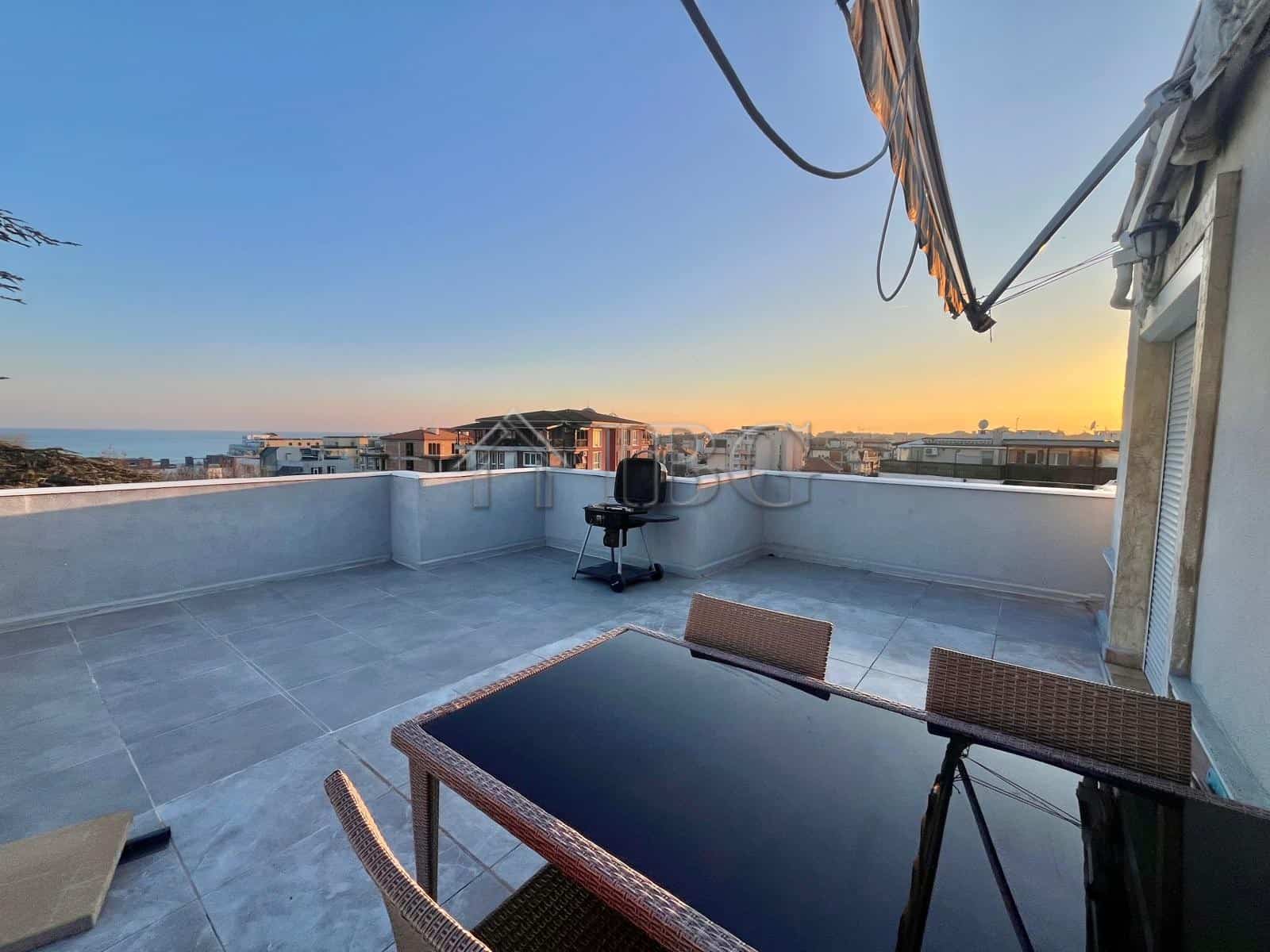 Rooftop terrace with sea view and outdoor furniture in Ravda apartment.
