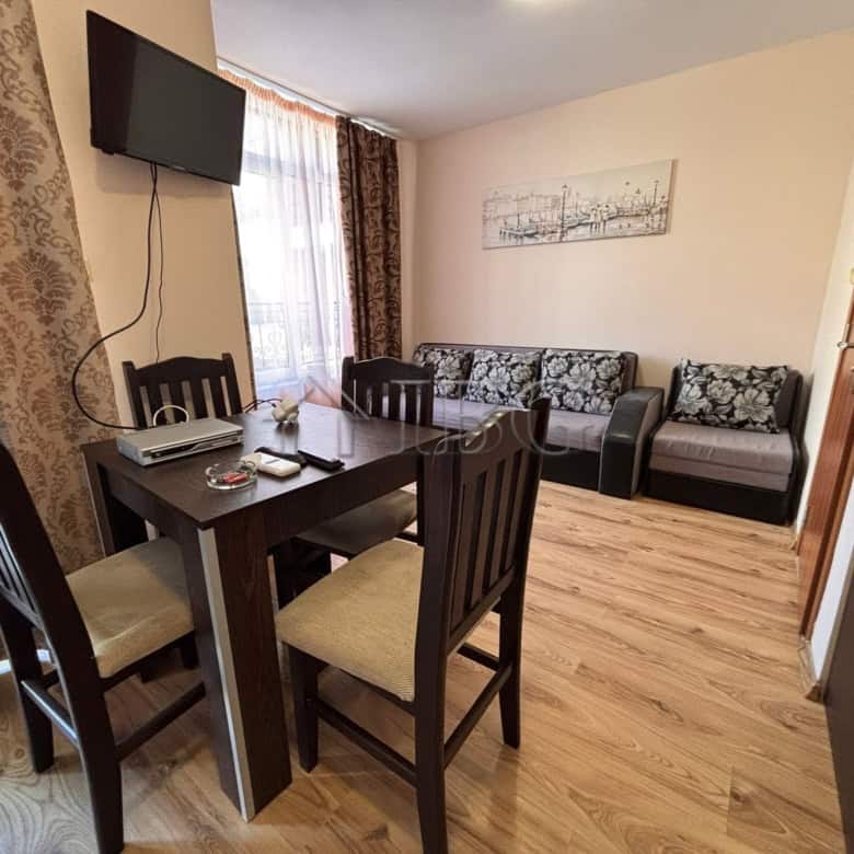 Comfortable living room with dining area and sofa, perfect for relaxing.