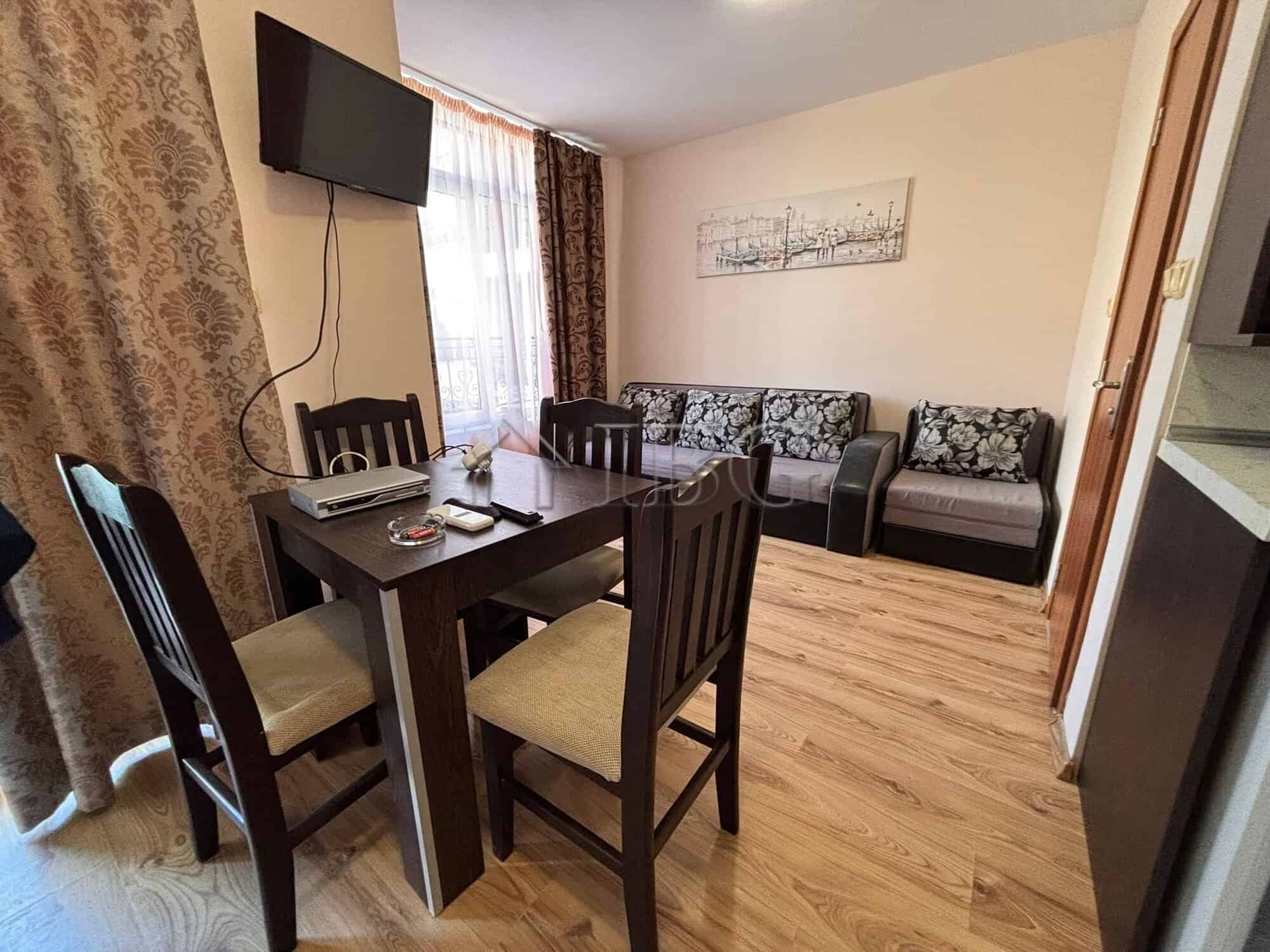 Comfortable living room with dining area and sofa, perfect for relaxing.