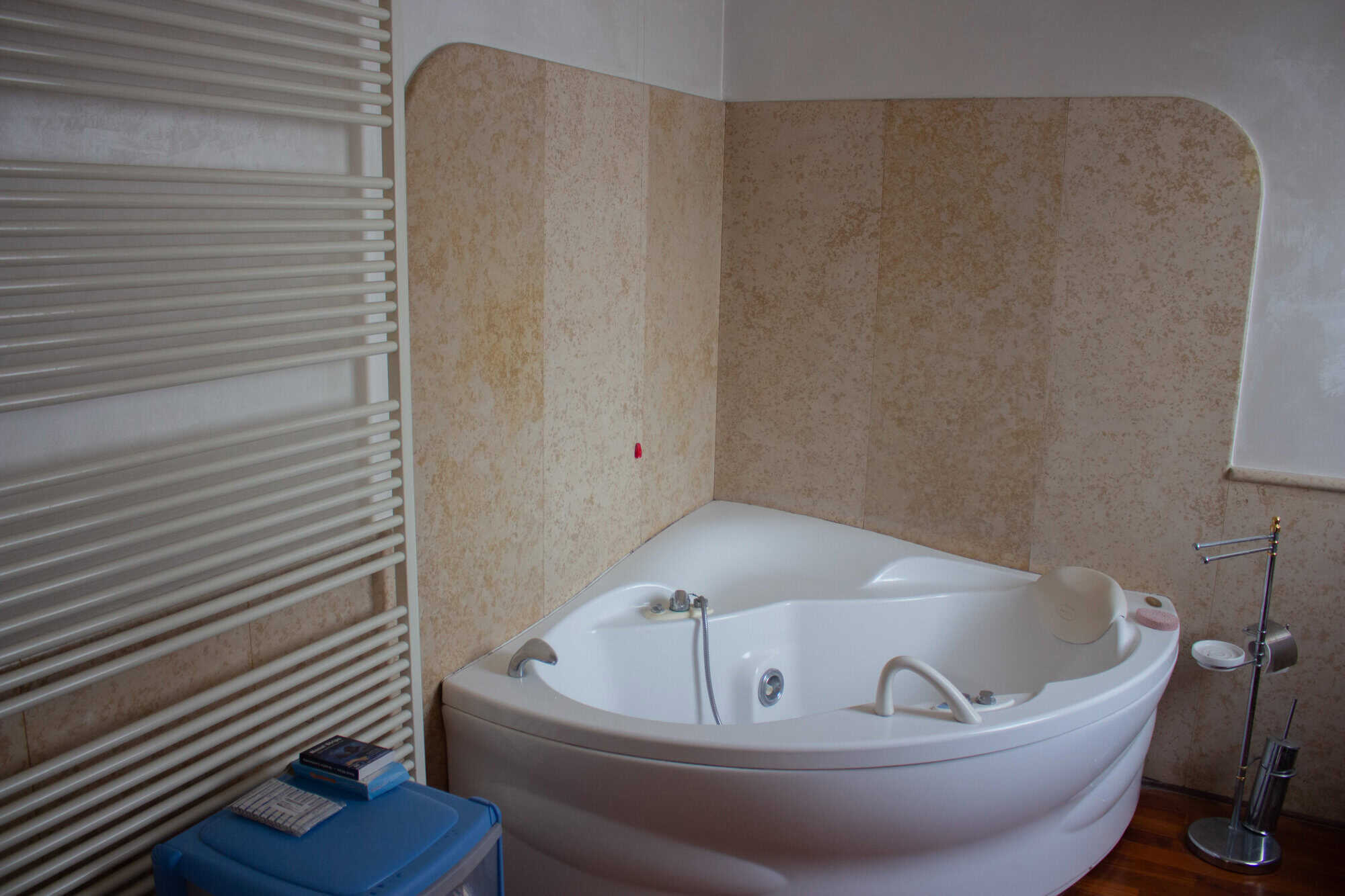 Luxury corner whirlpool bathtub for home spa and relaxation.