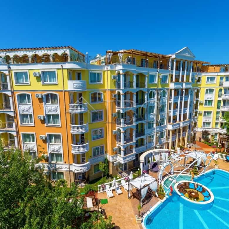 Bright yellow and white one-bedroom apartment in Sunny Beach with balcony views.