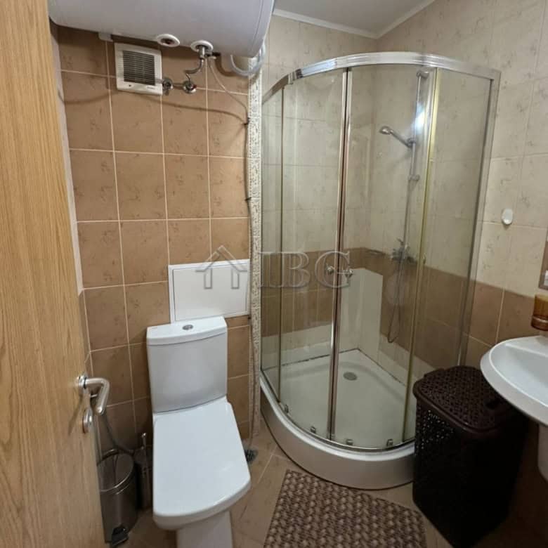 Small bathroom with shower, toilet, and sink in Royal Sun apartment, Sunny Beach.