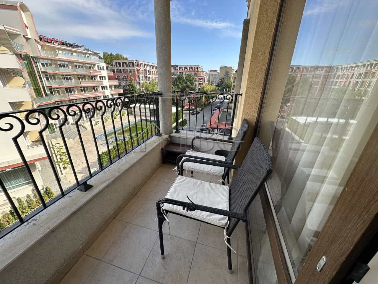 Balcony view of Royal Sun, Sunny Beach, with outdoor seating and cityscape.