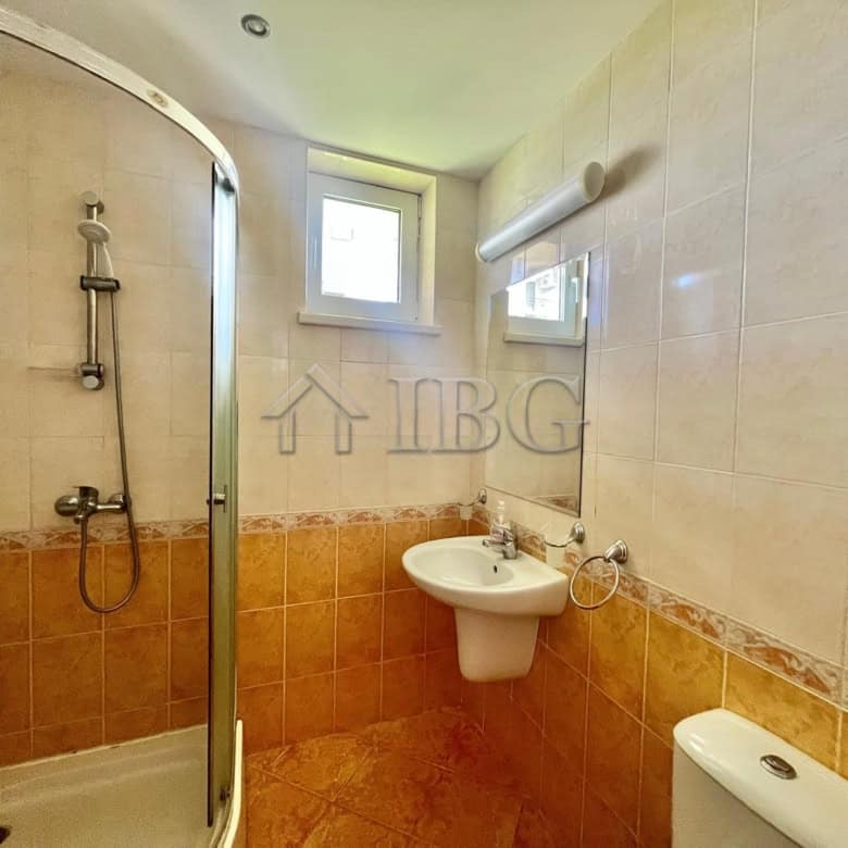 Bright bathroom with shower, sink, and window in Sveti Vlas.
