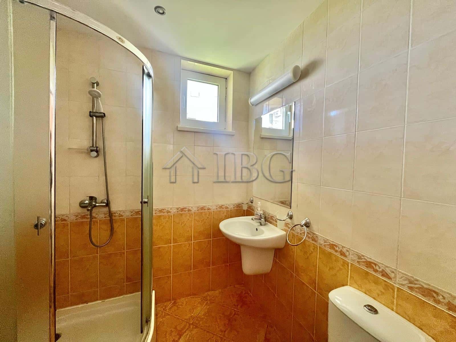 Bright bathroom with shower, sink, and window in Sveti Vlas.